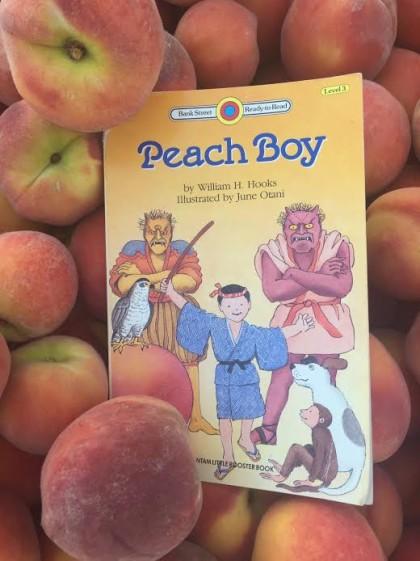 Peach boy in bin of peaches